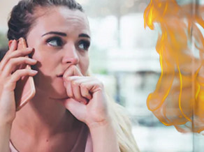 Woman talking on the phone next to a flame